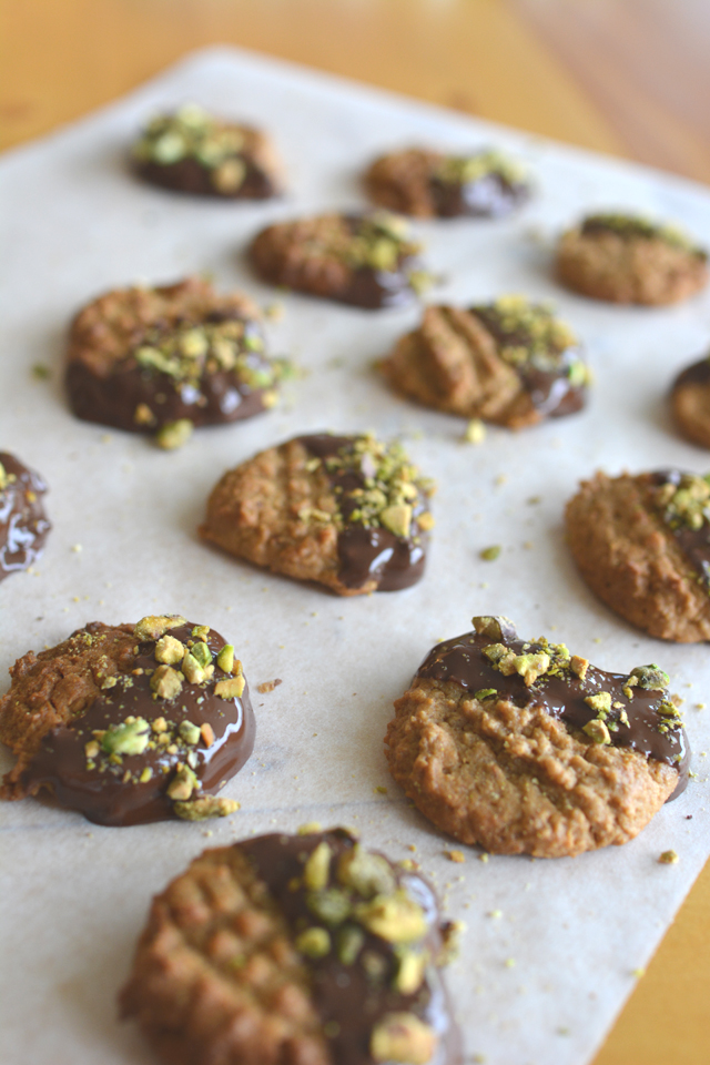 Flourless Peanut Butter Cookies, dipped in chocolate and sprinkled with pistachios. These cookies may only have 6 Ingredients, but they will blow your mind! Click through for the recipe!