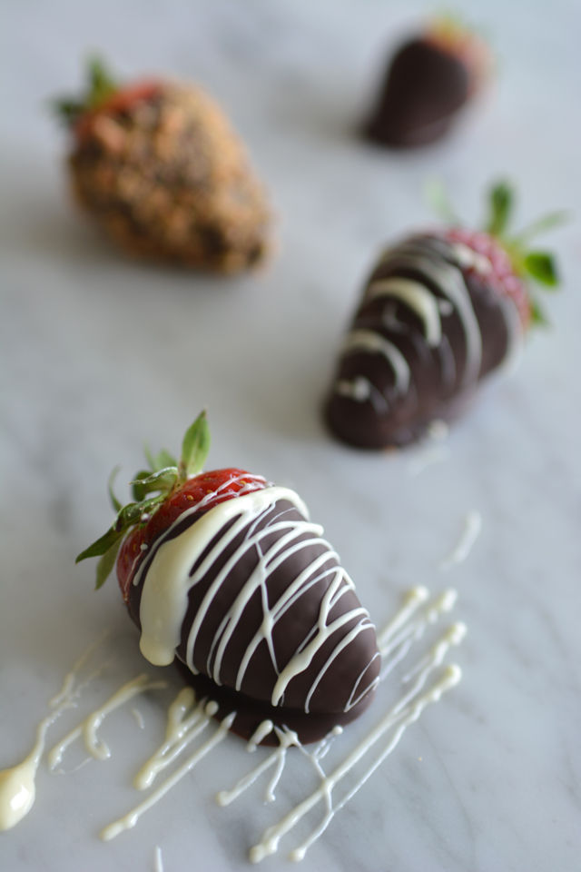 close-up image of fresh strawberries coated in chocolate with a drizzle of white chocolate