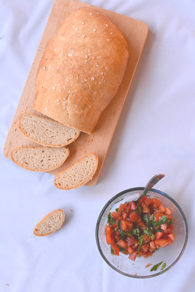 Homemade bread for bruschetta with tomatoes and basil.