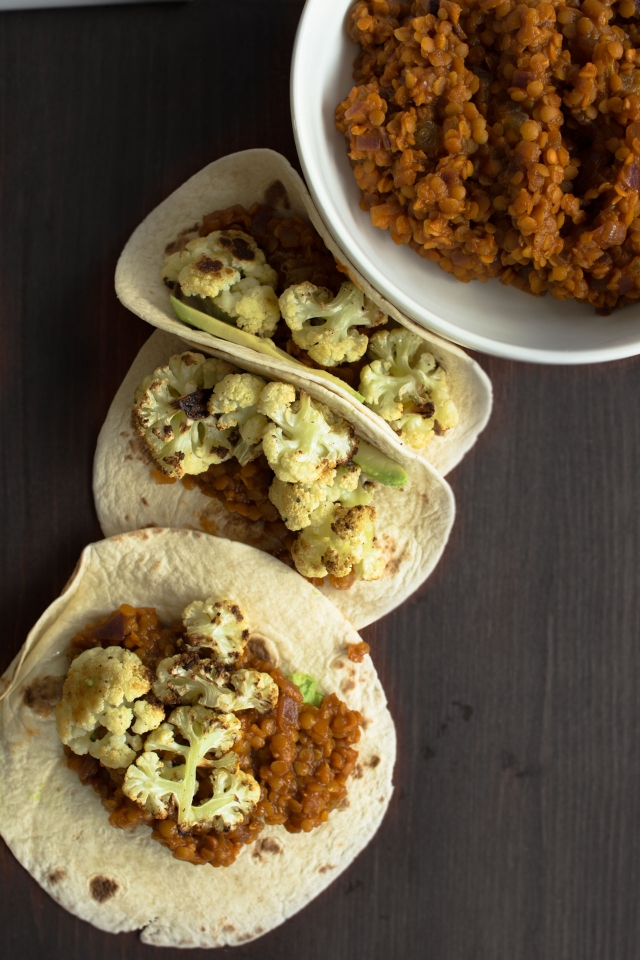 tacos filled with roasted cauliflower, spicy lentils, sultanas and avocado