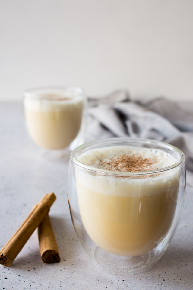 an image of two glasses full homemade eggnog with nugmeg on top