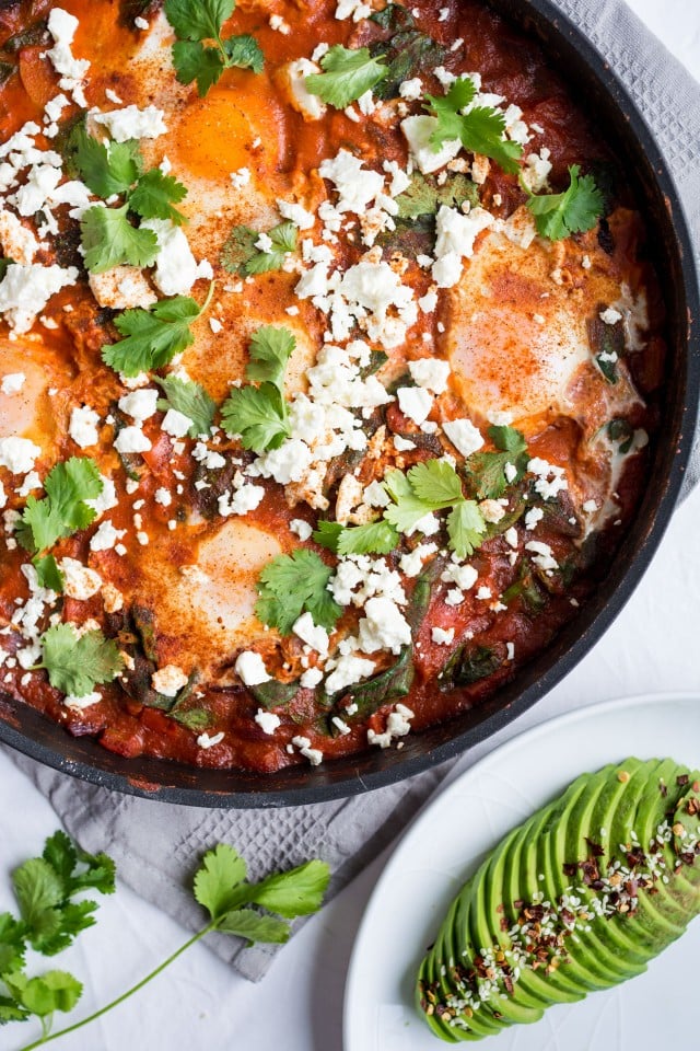 Shakshuka with Spinach is a delicious one skillet breakfast that is ready in under 30 minutes! Full of veggies and protein, this easy, quick breakfast recipe will fill you up for a great day!
