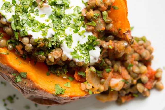 Sweet Potato stuffed with lentils, kale and sun dried tomatoes are a great warming meal when it's freezing cold outside!
