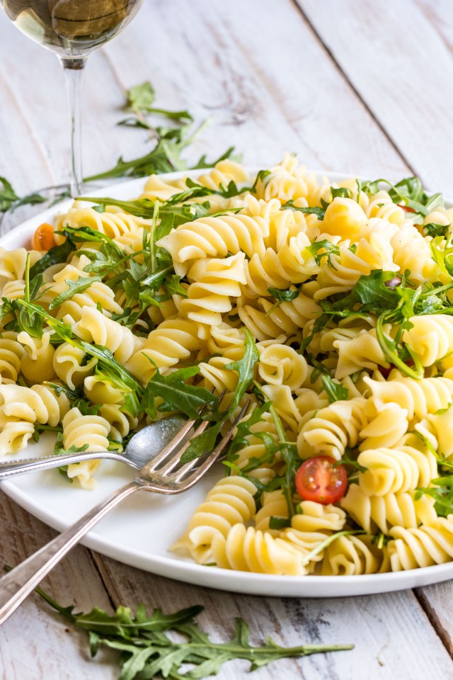 Close up view of Lemon Rocket Pasta Salad with cherry tomatoes.