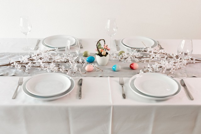 an image of a well-set table with arranged plates and neatly placed cutlery, ready for a meal.