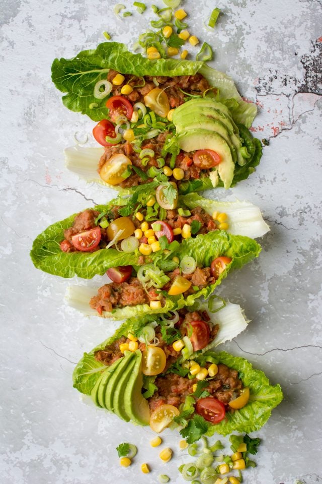 Refried Bean Lettuce wraps, perfect for a vegan lunch on the go, or just a lighter dinner option! Get this super easy recipe here!