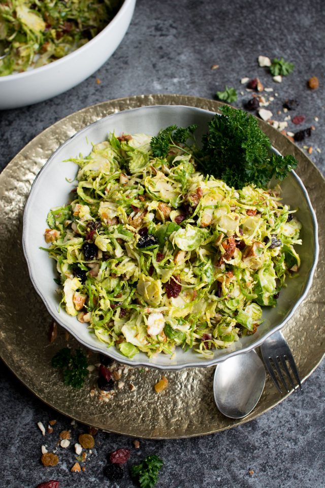 Raw Brussels Sprouts Salad with Dried Fruit served in a baked avocado!